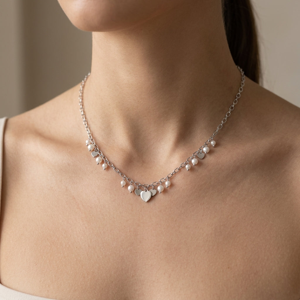 Upper-body scene of a fashion model wearing the Hearts & Pearls Pendant Necklace, highlighting its delicate design and subtle elegance on a minimalistic outfit.