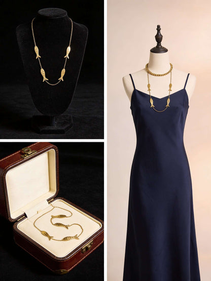 Catch Of The Day gold-tone chain necklace featuring four stylized fish charms, shown on a display, mannequin, and in a box.