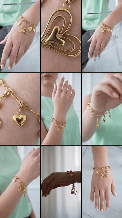 Gold chain bracelet featuring multiple heart charms, including a large layered heart pendant, on a woman's wrist.