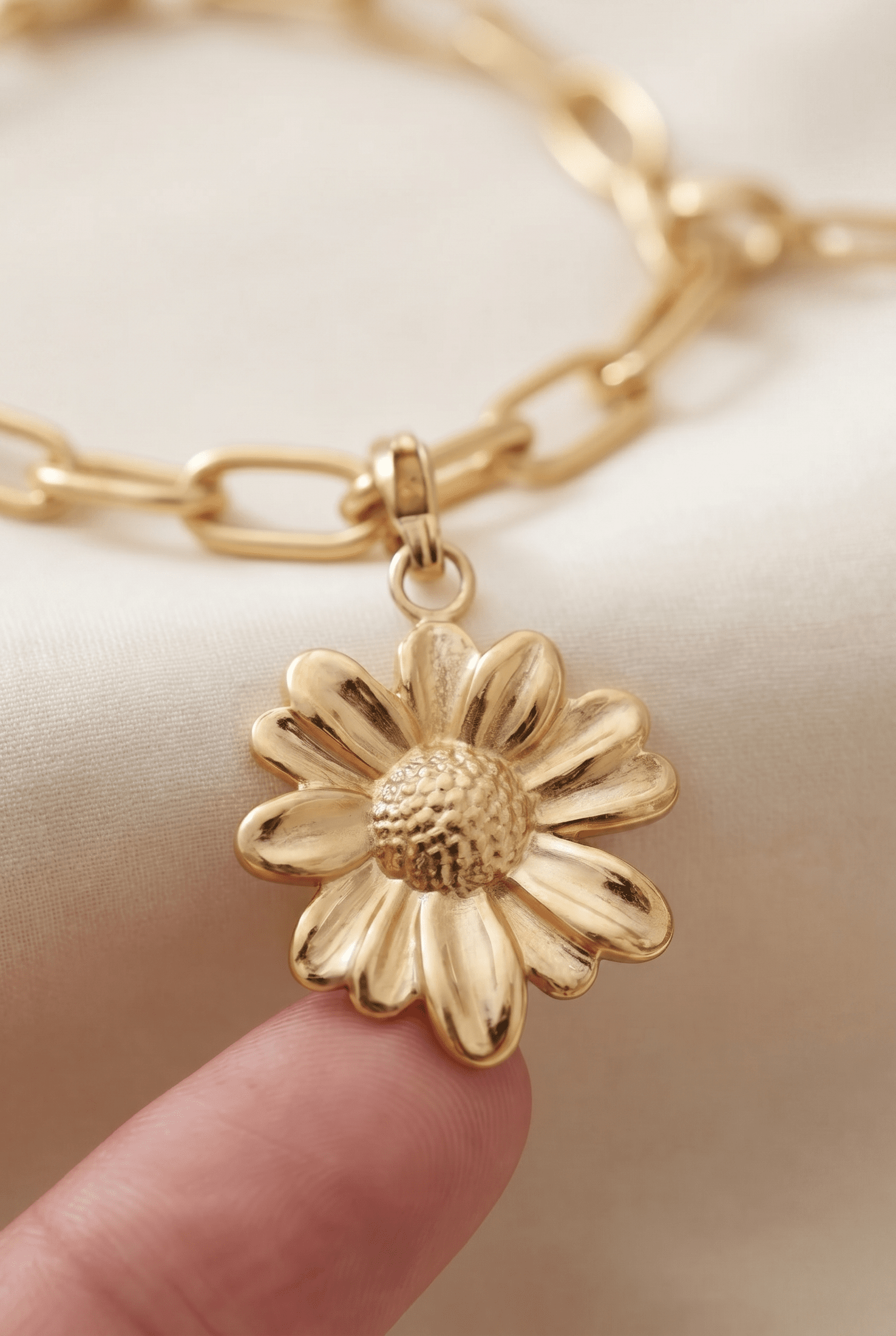 Gold-tone metal Elegant Floral Link Bracelet featuring a daisy charm with a textured center on a chunky chain.