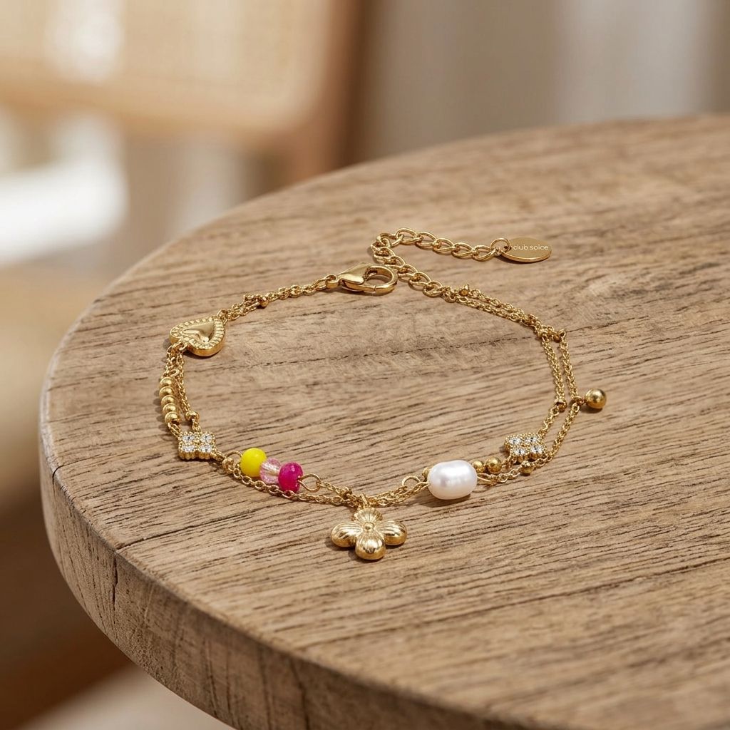 Close-up of Lucky Charm Stack bracelet with pearls rhinestones floral and heart motifs on wooden surface, highlighting delicate multi-layered design.