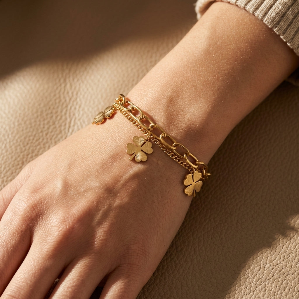Delicate stainless steel lucky you bracelet with lobster clasp on textured leather surface, showcasing fine detail and sheen.