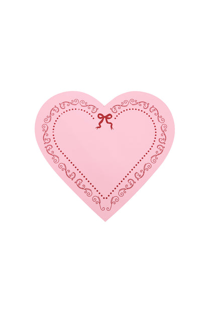 Pink heart-shaped lid featuring decorative red scrolls and a ribbon bow design