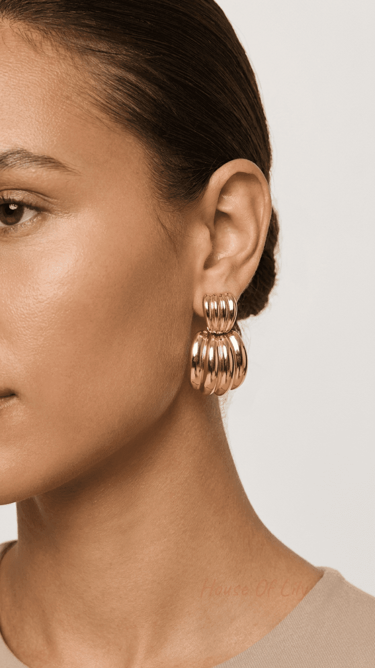 Chunky Vibe Hoops featuring a polished gold, ribbed croissant design on a model against a neutral background.