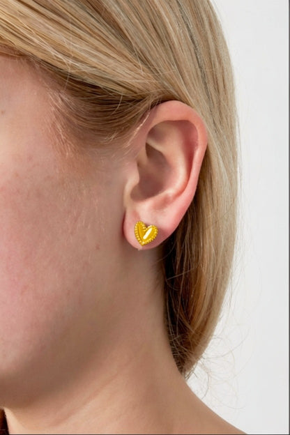 Cutie Heart Clips: Small, shiny gold-tone heart-shaped stud earrings with a delicate beaded edge on an earlobe.