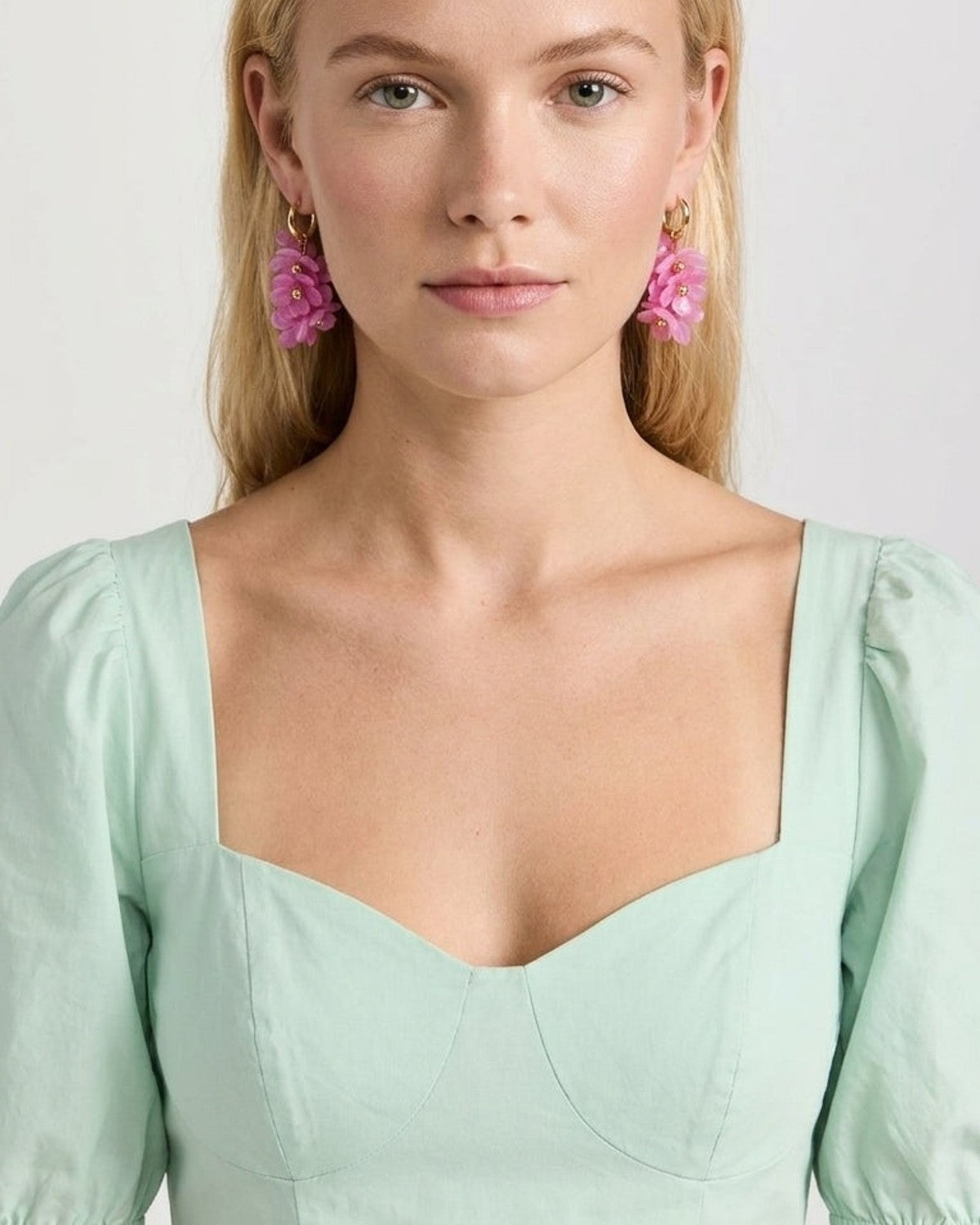 Charming Flower Drop Earrings worn on model, featuring pink layered petals on gold hoops.
