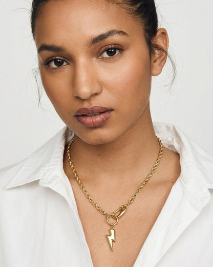 Gold-tone rope chain necklace featuring a lightning bolt pendant attached with a clasp.