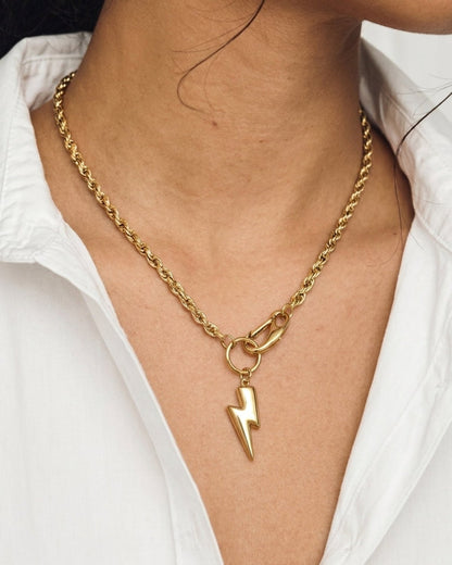 Gold tone rope chain necklace with a polished lightning bolt pendant on a clasp.