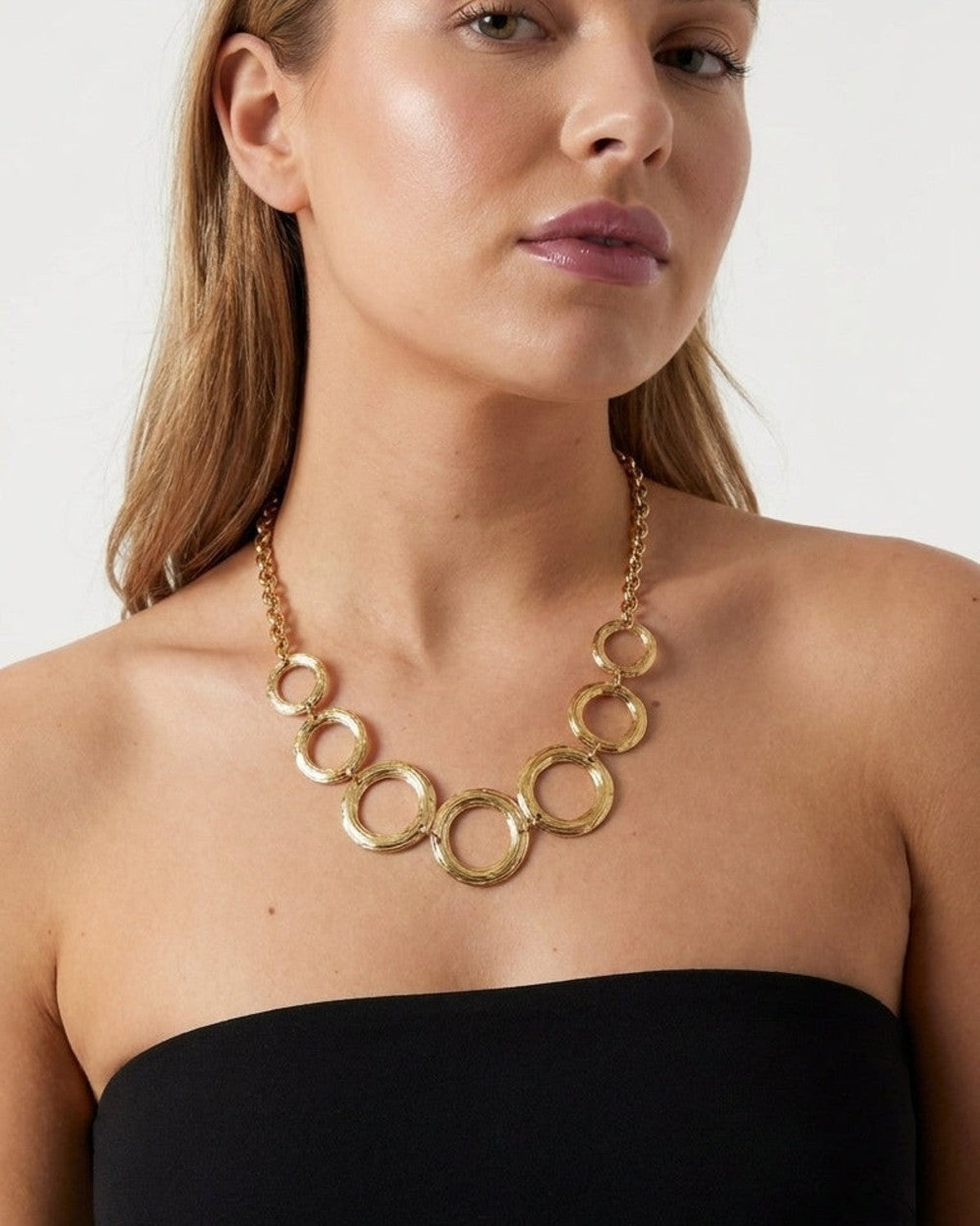 Gilded Chain Statement Necklace with textured interlocking gold hoops suspended from a link chain.
