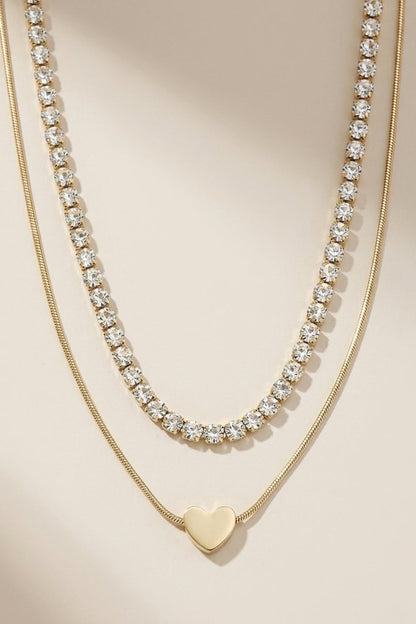 Layered Gold Heart Necklace: Two-strand gold necklace with a crystal tennis strand and a heart pendant strand.