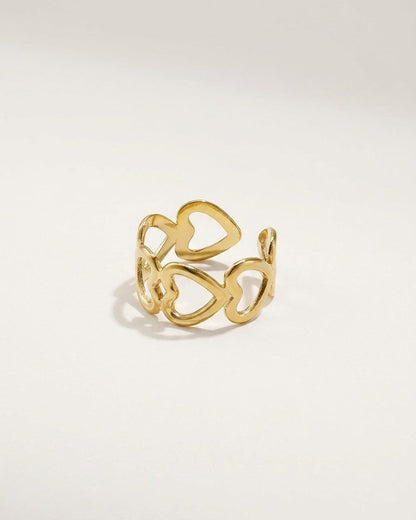 Gold-toned metal ring featuring an open-work band of interconnected cutout hearts.