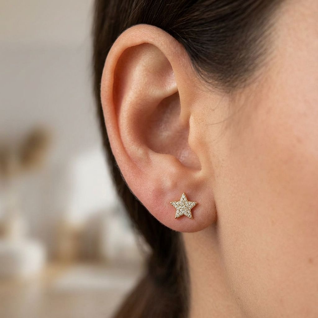 Close-up of Starry Night Studs earrings on a model's earlobe, showcasing lightweight star design with zircon inlays and subtle shimmer.