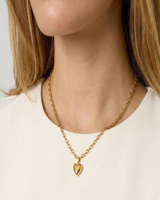 Close-up of the Sweetheart Silver Chain showing a dainty stainless steel heart pendant on textured fabric, highlighting its fine design and sparkle.